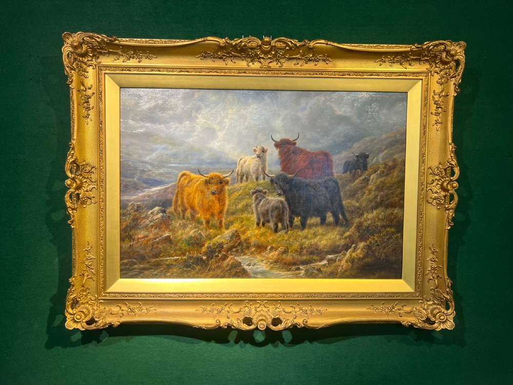A late 19th-century oil painting depicting Highland cattle on a Scottish moor, set within an ornate gilded frame.