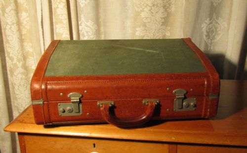 A Green Canvas and Tan Leather Suitcase