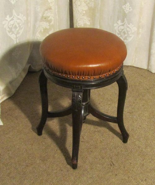 A Charming Victorian Ebonised Mahogany and Leather Piano Stool