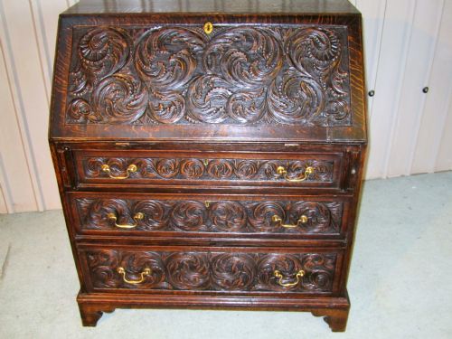 A Victorian Gothic Carved Oak Bureau