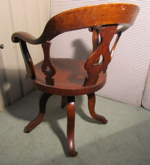 fig 1. A Swiveling Elm and Mahogany office chair or desk chair on Casters 