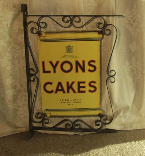 Enamel Shop Sign Lyons Cakes in a Wrought Iron Hanging Frame