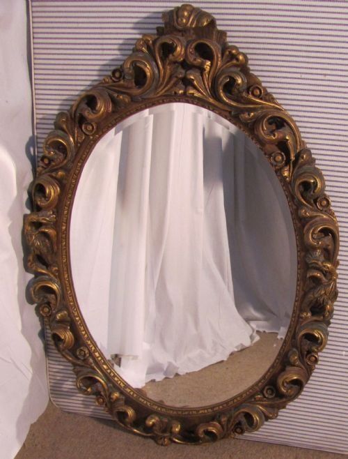 A Large Very Decorative Carved Oval Gilt Wall Mirror