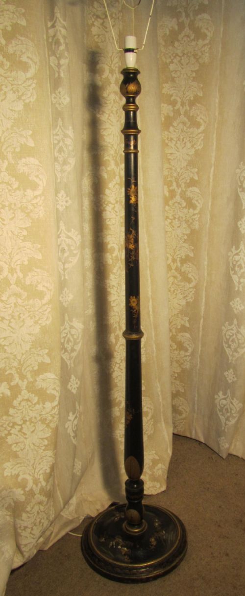 A Black Lacquer and Gold Floor Standing Lamp