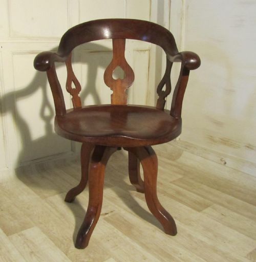 fig 1. A Swiveling Elm and Mahogany Office Chair or Desk Chair