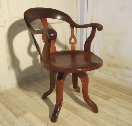 A Swiveling Elm and Mahogany Office Chair or Desk Chair