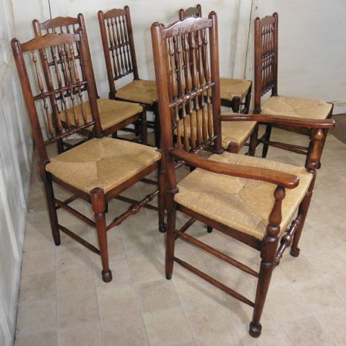 A Set of 7 Spindle Back Country Oak Dining Chairs