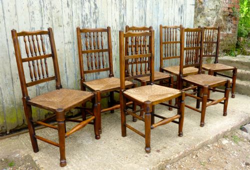 A Set of 7 Spindle Back Country Oak Dining Chairs