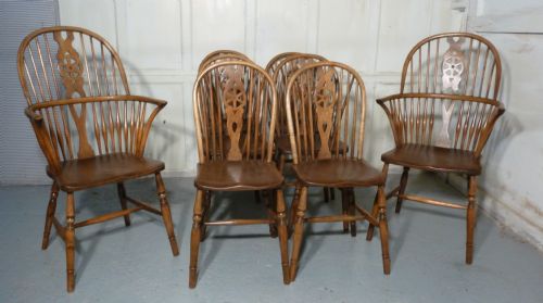 A Set of 8 Elm and Ash Wheel Back Windsor Chairs