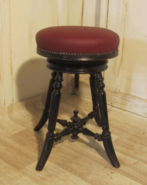 A Charming Victorian Ebonised Mahogany and Leather Piano Stool