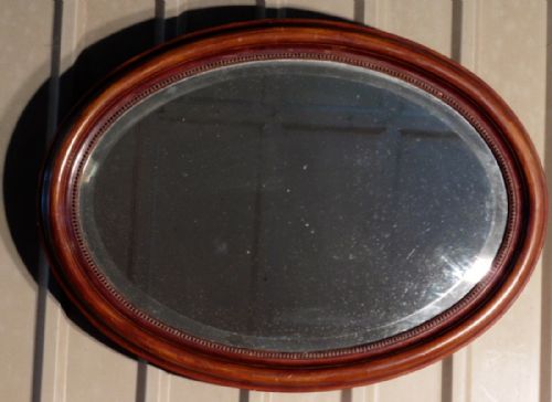 A Large Edwardian Mahogany Oval Mirror