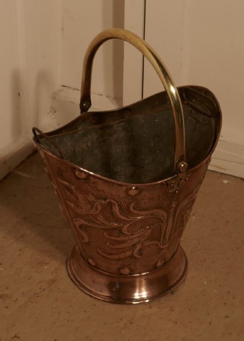 fig 1. An Art Nouveau Embossed Copper Helmet Coal Scuttle with Liner