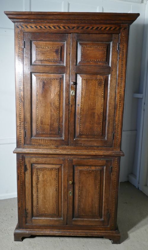 An 18th Century Inlaid Oak Estate or Housekeepers Cupboard