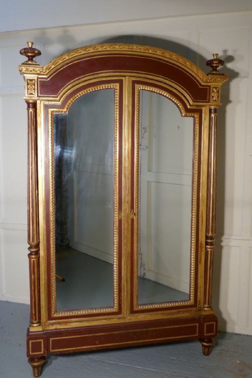 A Glamorous French Art Deco Gold and Burgundy Armoire