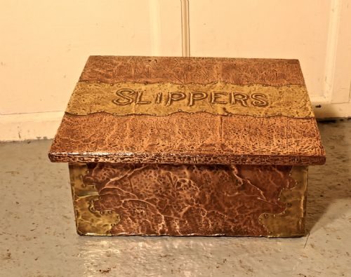An Arts and Crafts Hand Beaten Copper and Brass Fireside Slipper Box