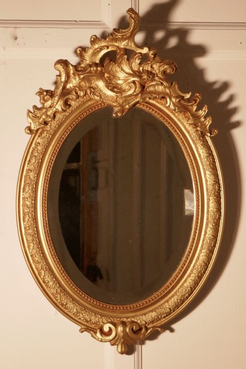 A Dainty French Rococo Oval Gilt Wall Mirror