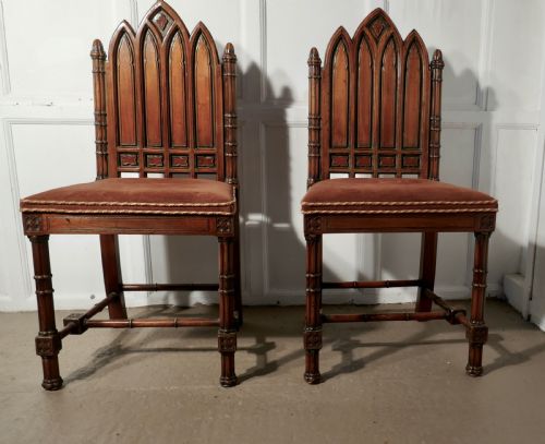 A Pair of Pugin Style Arts and Crafts Carved Oak Hall Chairs