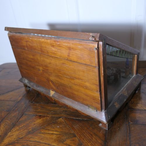 fig 1. An early 20th-century wooden diorama display case featuring a miniature scene of a monkey saloon titled Bills Bar.
