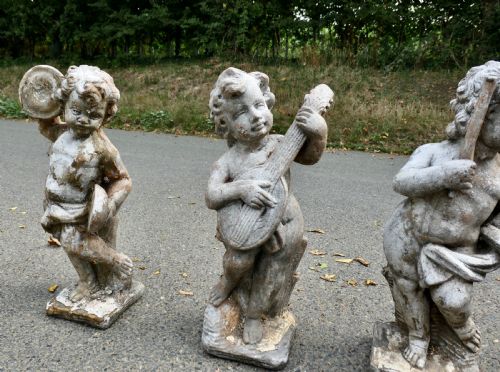 A SET OF 4 WEATHER WORN CHERUB STATUES WITH INSTRUMENTS - ADDITIONAL PHOTO 3