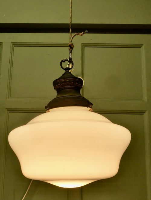 fig 1. A set of four vintage industrial ceiling pendant lights featuring white opal glass shades and aged brass galleries.