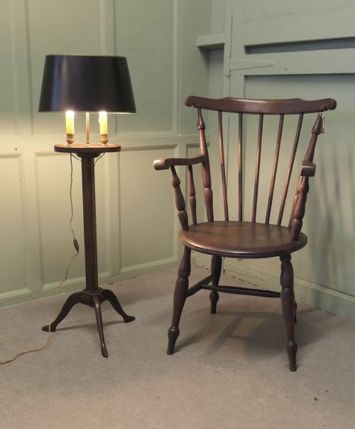 fig 1. An antique mahogany bouillotte floor lamp featuring a dark oval shade mounted over twin faux-candle sockets on a tripod base.