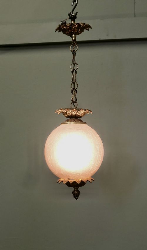 fig 1. An Art Deco hanging pendant light featuring a spherical crackle glass globe supported by foliate brass mounts and chain suspension.