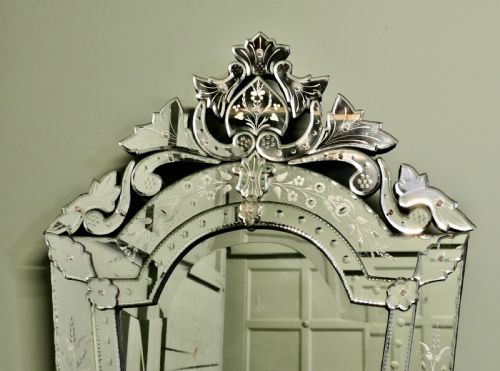 fig 1. A tall Art Deco Venetian wall mirror featuring hand-etched floral motifs, a contoured crest, and bevelled border panels.