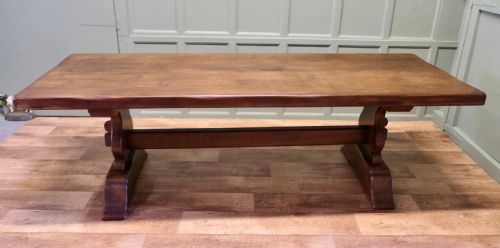 fig 1. A large 19th-century French oak refectory table featuring a solid plank top, shaped trestle ends, and a central connecting stretcher.
