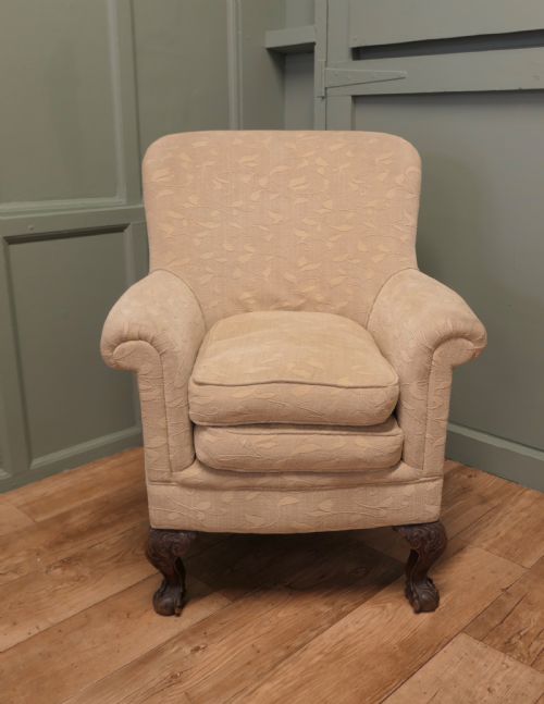 fig 1. A Victorian upholstered tub armchair in cream patterned fabric with carved timber legs.