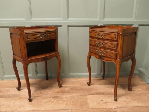 fig 1. A pair of French cherry wood bedside tables featuring cabriole legs, brass handles, and carved shell motifs, one configured with an open shelf and the other with three drawers.