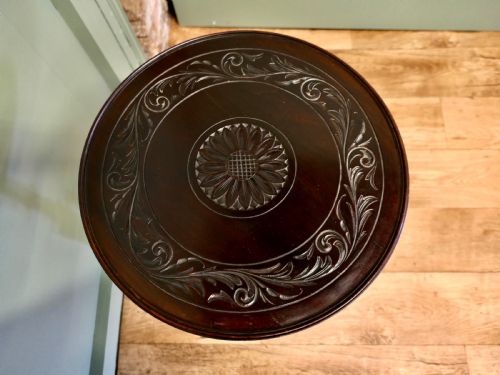 fig 2. A dark mahogany Art Nouveau wine table featuring a carved circular top, turned stem, and three swept legs with a carved central pendant.