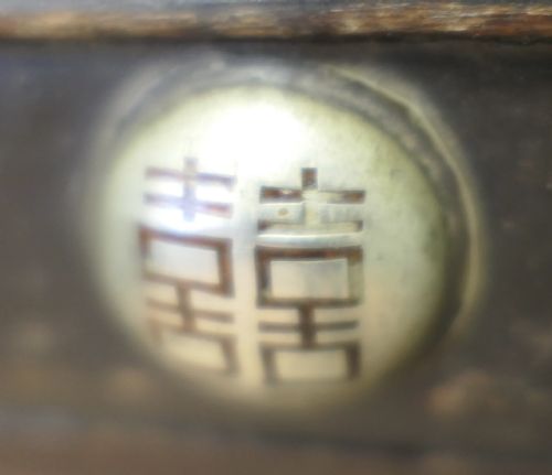 fig 1. A dark brown wooden Korean Bandaji chest adorned with elaborate silver-coloured brass plating, geometric studs, etched metal panels, and three top drawers.