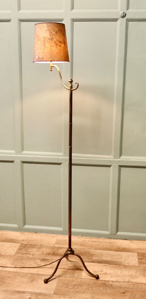A French Arts and Crafts brass floor lamp featuring a slender stem, tripod base, curved adjustable arm, and a mottled parchment shade. View III