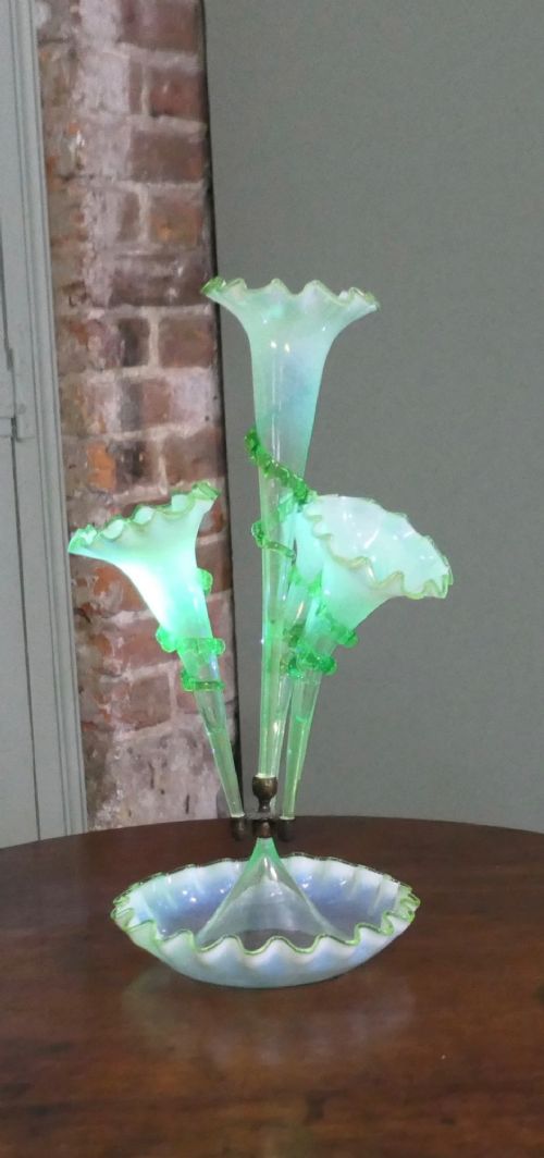 A nineteenth-century hand-blown uranium glass epergne featuring four crimped trumpet stems with applied green glass trailing mounted above an opalescent bowl base. View III