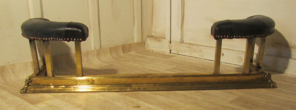 A Victorian Brass and Leather Club Fender