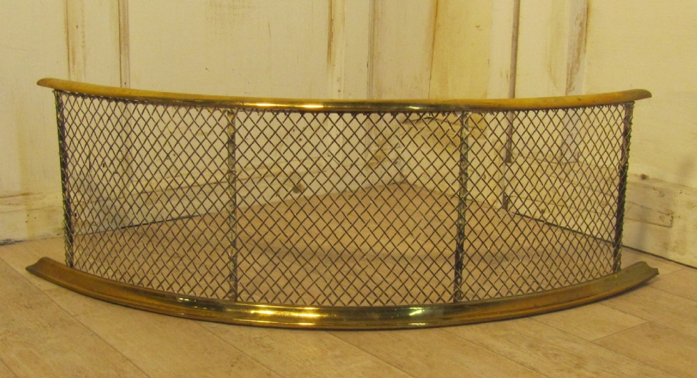 A Half Moon Curved Victorian Brass and Iron Club Fender 