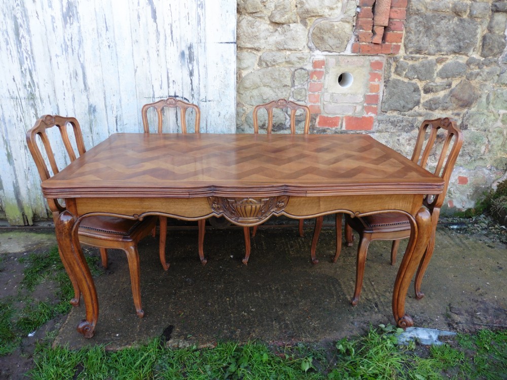 A Large French Parquetry Draw Leaf Table and 6 Chairs