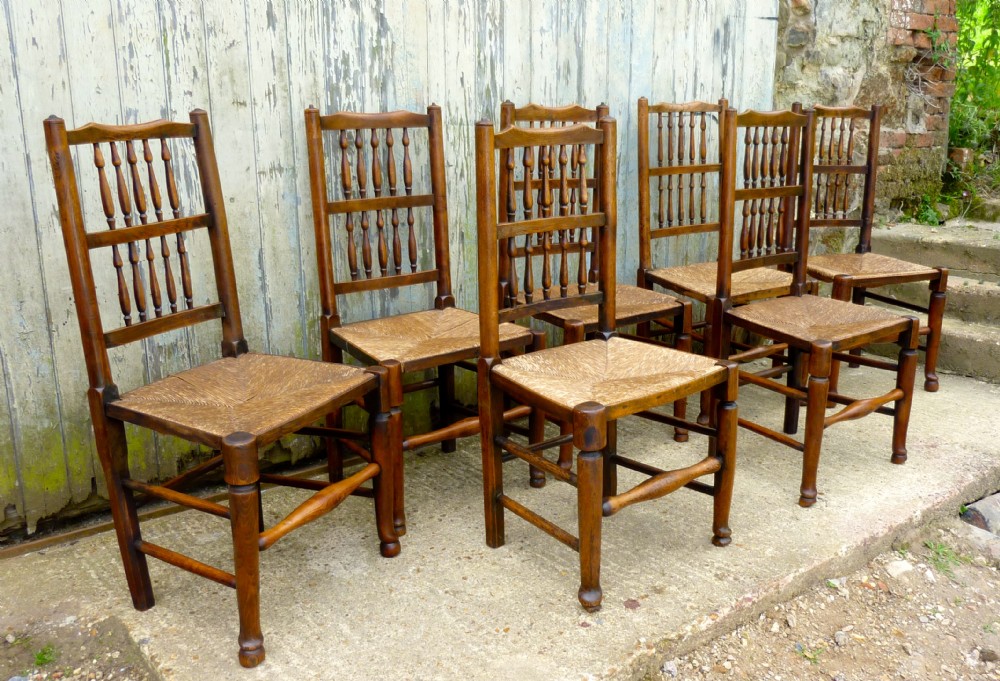 A Set of 7 Spindle Back Country Oak Dining Chairs 