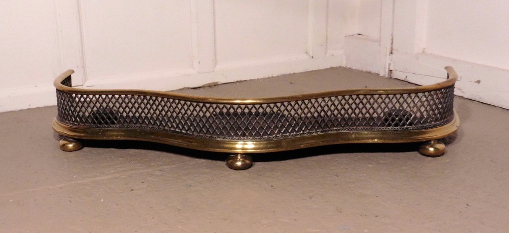 A Superb Quality Serpentine Victorian Brass and Iron Fender  