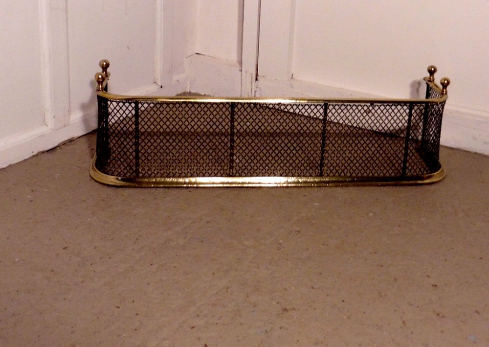 A Victorian Brass and Iron Club Fender