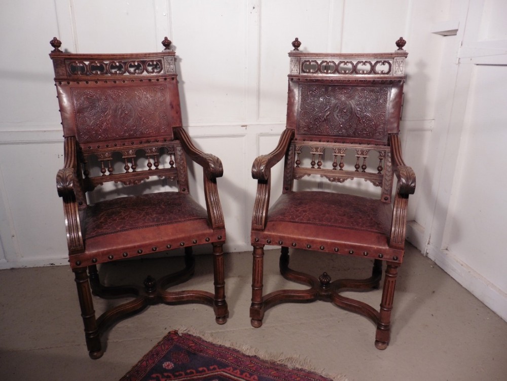 A pair of French Gothic Walnut and Leather Library Chairs 