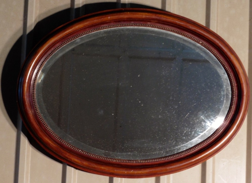 A Large Edwardian Mahogany Oval Mirror