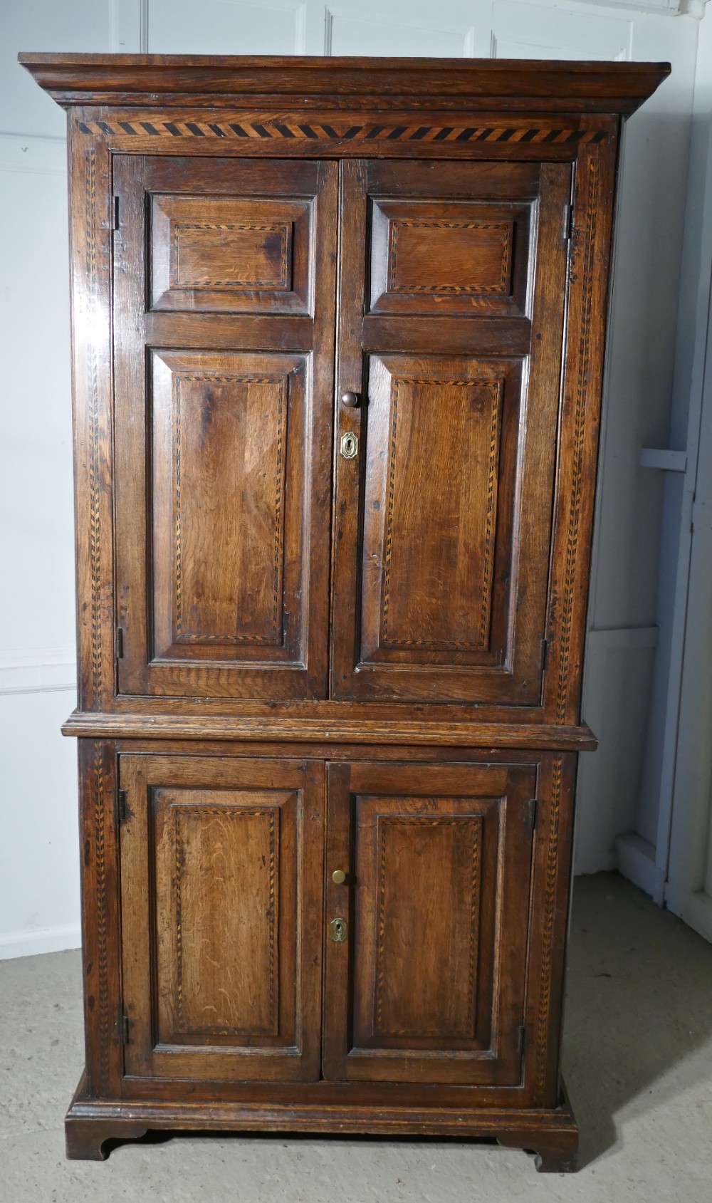 An 18th Century Inlaid Oak Estate or Housekeepers Cupboard