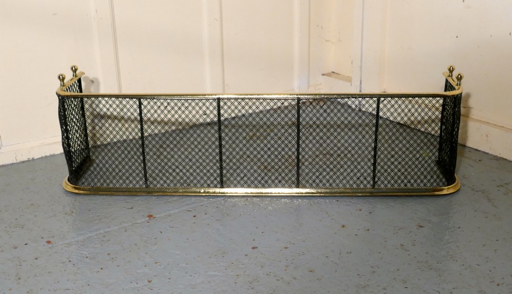 A Victorian Brass and Iron Club Fender