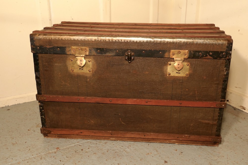 A Vintage Brass and Bound Canvas Travel Steamer Trunk