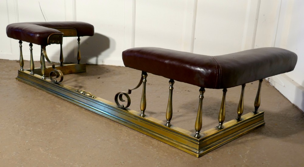 A Large Arts and Crafts Brass and Leather Club Fender