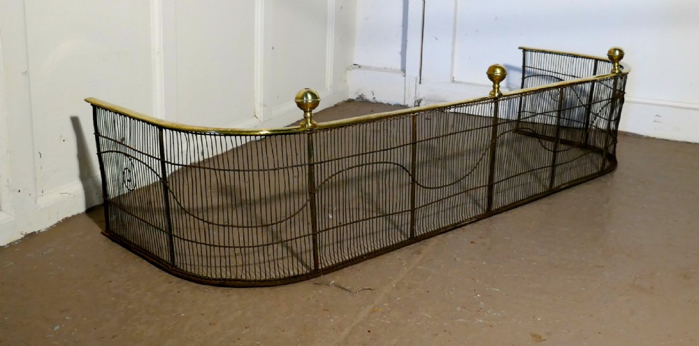 A Georgian Brass and Iron Club Fender