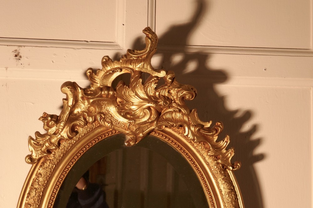 A Dainty French Rococo Oval Gilt Wall Mirror View V
