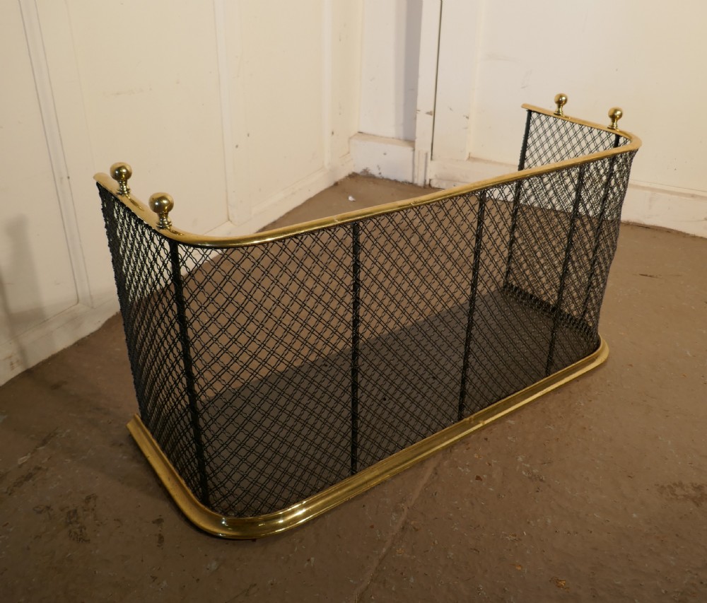 A Victorian Brass and Iron Fender or Fireguard View V