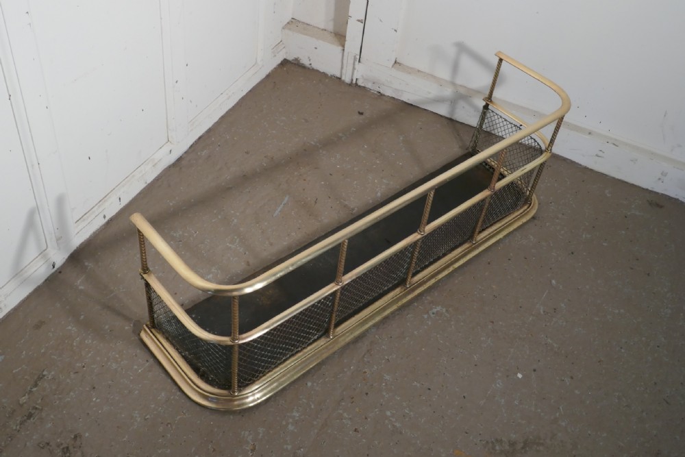 A Victorian Brass Club Fender 